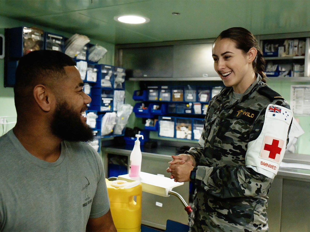 A Navy medic interacts with a patient.